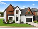 Stunning two-story home boasts a modern design, attached garage, and manicured lawn at 5428 Carmel Rd, Charlotte, NC 28226