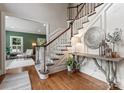 Grand entryway with hardwood floors, curved staircase, and decorative wall accents at 235 Grey Rd, Davidson, NC 28036