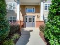 Brick building exterior with gray door and landscaping at 11719 Ridgeway Park Dr, Charlotte, NC 28277