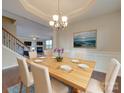 Elegant dining room with chandelier and hardwood floors at 131 Renville Pl, Mooresville, NC 28115