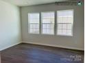 Bright bonus room with three large windows and hardwood floors at 4467 Potters Wheel Dr, Fort Mill, SC 29715