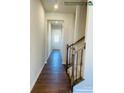 Long hallway with stairs and dark hardwood floors at 4467 Potters Wheel Dr, Fort Mill, SC 29715