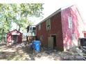 Back of the house with a screened porch and outbuildings at 713 Sikes Ave # 2, Wadesboro, NC 28170