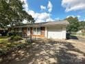 Brick ranch house with attached garage and landscaped yard at 140 E Chamblee Dr, Salisbury, NC 28147