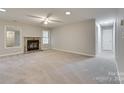 Living room with a fireplace, carpet, and neutral tones at 151 Cedar Hollow St, Fort Mill, SC 29715
