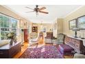 Living room with hardwood floors, comfy chairs, and a ceiling fan at 1026 Holly Dr, Gastonia, NC 28054