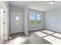 Bright entryway with hardwood floors, large windows, and view of fields at 1026 Heath Helms Rd, Monroe, NC 28110