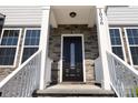 Elegant entryway with stone details and a black front door at 1026 Heath Helms Rd, Monroe, NC 28110