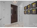 Elegant entryway with chandelier and Broadway Playbill art at 230 S Tryon St # 1101, Charlotte, NC 28202