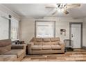 Living room with hardwood floors, neutral-toned sofas, and large windows at 515 Suttle St, Shelby, NC 28150
