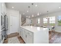 Open kitchen with white cabinets, island, and dining area at 112 Atterberry Aly, Charlotte, NC 28217