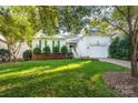 White house with green shutters and a two-car garage at 272 Millingport Ln, New London, NC 28127
