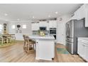 Modern kitchen with white cabinets, island, and stainless steel appliances at 4828 Maiden Creek Way, Maiden, NC 28650