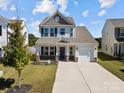 Two-story home with gray roof and brick facade, welcoming front porch at 1109 Freeman View Dr, Albemarle, NC 28001
