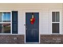 Inviting front door with a fall-themed wreath and brick details at 1109 Freeman View Dr, Albemarle, NC 28001