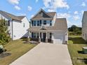 Two-story home with gray roof and brick facade, welcoming front porch at 1109 Freeman View Dr, Albemarle, NC 28001