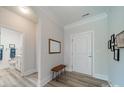 Bright entryway with wood bench, mirror, and view of bathroom at 2014 Newstyle Way, Tega Cay, SC 29708