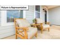 Two wooden chairs sit on a front porch, offering a relaxing view at 109 Saidin Ln, Troutman, NC 28166