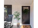 Black front door with glass panels and a welcoming mat at 202 Ross St, China Grove, NC 28023