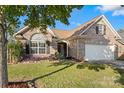 Brick ranch home with a two-car garage and well-manicured lawn at 3327 Flagler Cir, Midland, NC 28107