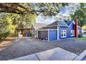 View of the home's side, showcasing a carport and gravel parking area at 275 S Church St, Mooresville, NC 28115