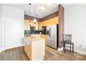 Modern kitchen with light wood cabinets, granite counters, and stainless steel appliances at 706 N Davidson St, Charlotte, NC 28202