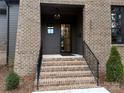 Brick front exterior with a charming covered entryway and stairs at 5001 Doris Ave, Charlotte, NC 28205