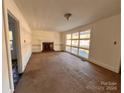 Spacious living room with built-in shelving and fireplace at 704 Mcadenville Rd, Lowell, NC 28098
