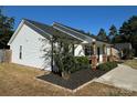 Side view of a charming white house with landscaping and a walkway at 1719 Johnson St # 2, Albemarle, NC 28001