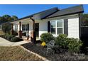 White house with black shutters, brick columns, and a landscaped front yard at 1719 Johnson St # 2, Albemarle, NC 28001