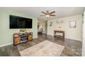 Spacious living room featuring hardwood floors, a large TV, and ample natural light at 1123 Golden Maple Ln, Chester, SC 29706