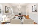 Elegant living room featuring hardwood floors, a fireplace, and a neutral color palette at 1218 Redcoat Dr, Charlotte, NC 28211