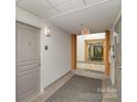 Clean and bright hallway with carpeted floors and neutral walls at 1320 Fillmore Ave, Charlotte, NC 28203