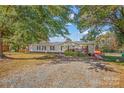 Ranch-style home with gravel driveway and mature trees at 120 Forest St, Rockwell, NC 28138