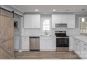 Kitchen with white cabinets, stainless steel appliances, and farmhouse sink at 1207 S Poplar St, Landis, NC 28088