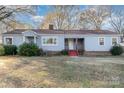 Gray siding ranch home with red steps, landscaping, and a large yard at 501 Hazel Ave, Kannapolis, NC 28083