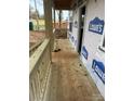 Unfinished front porch with wooden railings and steps at 1506 7Th St, Statesville, NC 28677