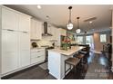 Modern kitchen with island, white cabinets, and stainless steel appliances at 231 Uptown West Dr, Charlotte, NC 28208