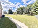 Large fenced backyard with a grassy area and a walkway at 2223 Chatham St, Newton, NC 28658