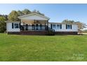 Ranch-style home with a covered porch and well maintained lawn at 1375 Woodend Ln, Clover, SC 29710