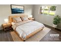 Bright bedroom with a king-size bed, two nightstands, and a window overlooking the backyard at 1831 J Julian Ln # A, Charlotte, NC 28208