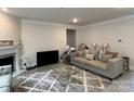 Living Room with fireplace, comfortable seating, and large windows at 177 Rhuidean Ct, Troutman, NC 28166
