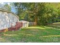 Side view of mobile home with wooden deck and storage shed at 1472 Fritts Ave, Fort Mill, SC 29715