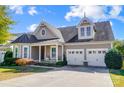 Beautiful two-story home with a charming front porch and two-car garage at 5021 Henshaw Rd, Waxhaw, NC 28173