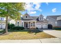 Beautiful two-story home with a charming front porch and two-car garage at 5021 Henshaw Rd, Waxhaw, NC 28173