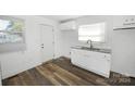 Simple white kitchen with granite countertops at 125 S Ervin Ave, Newton, NC 28658