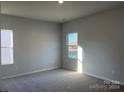Bright bedroom with carpeted floors and large window at 1040 Bull Dog Ln, Wingate, NC 28174
