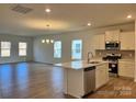 Open concept kitchen with island, stainless steel appliances, and white cabinetry at 1044 Bull Dog Ln, Wingate, NC 28174