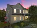 Stunning two-story home with lighted exterior at dusk at 309 Commodore Loop, Mooresville, NC 28117