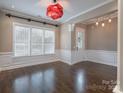 Bright dining room with hardwood floors, large windows, and elegant light fixture at 507 Quicksilver Trl, Fort Mill, SC 29708